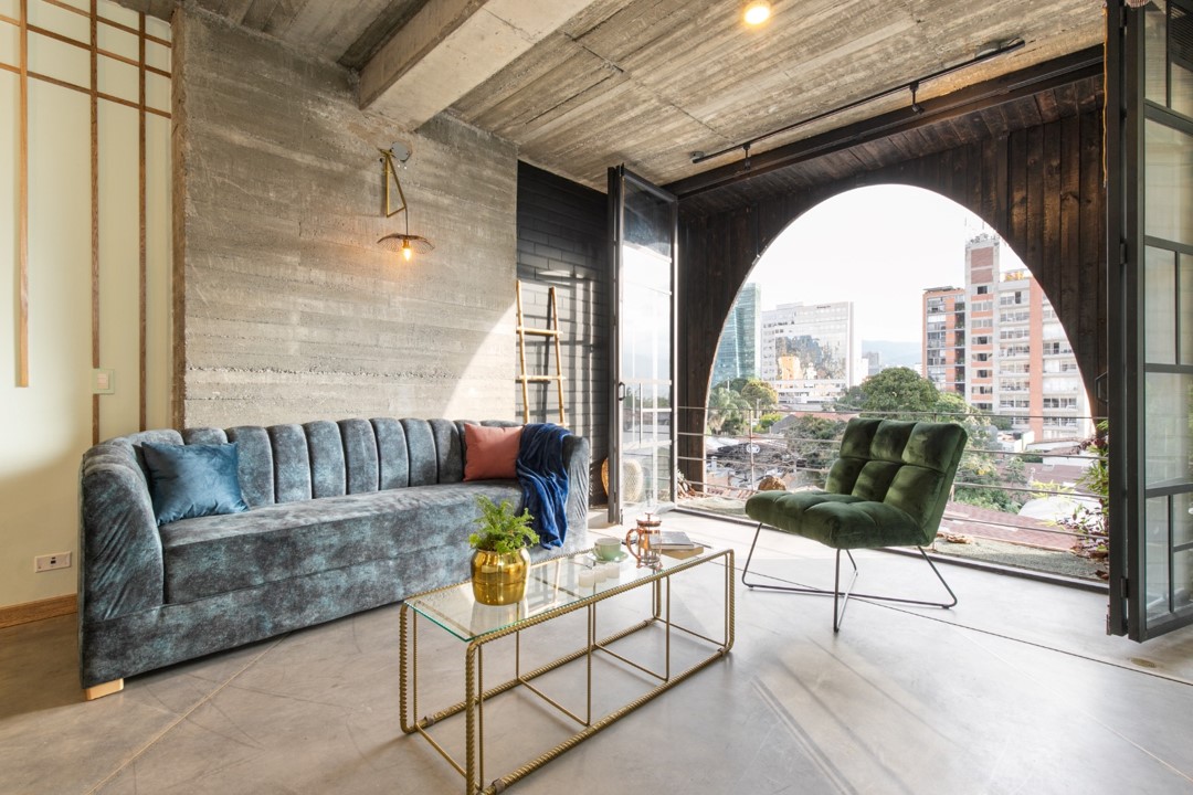 Spacious and well-lit living room in Hotel Medellin Nido Sky with designer furniture